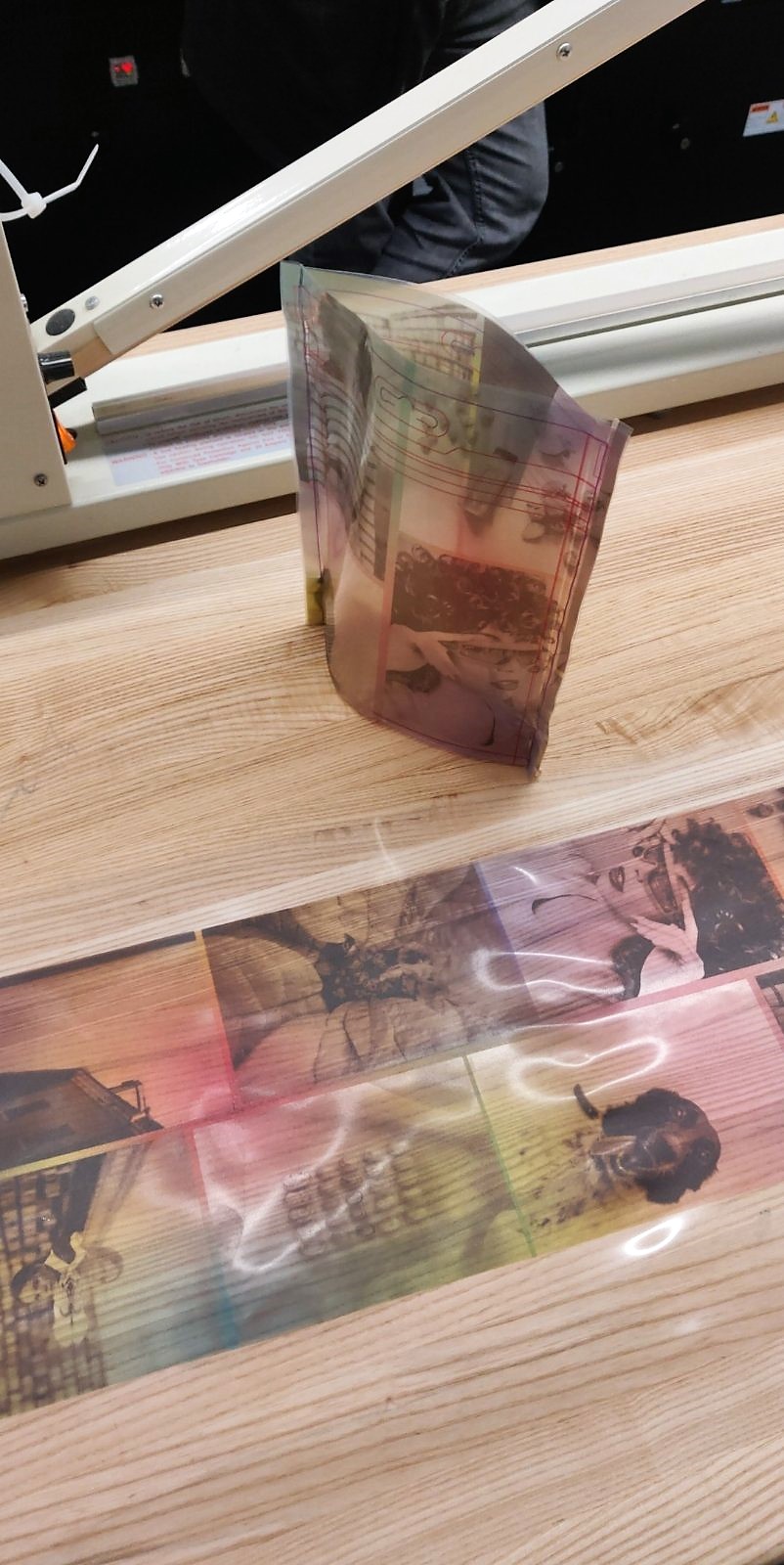 We used a heated wire to turn the UV-printed plastic sheet into a fully formed pouch. Not pictured is repurposing the zipper from other bags to make our prototypes even more functional